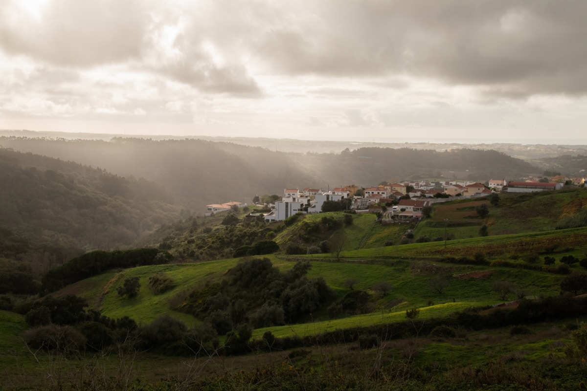A village nestled in rolling green hills, characteristic of Portugal’s interior highlands. Photo by Filipe Nobre on Unsplash